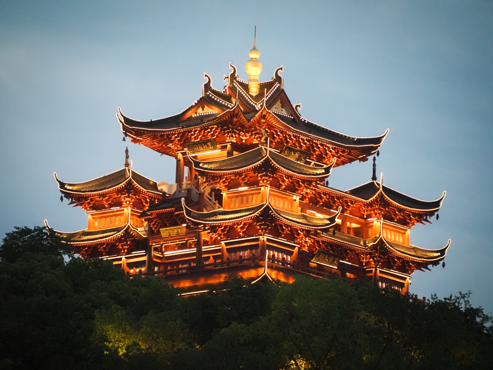 A large pavilion - more like a castle - at West Lake - lit up with lights along all of the curved roofs.