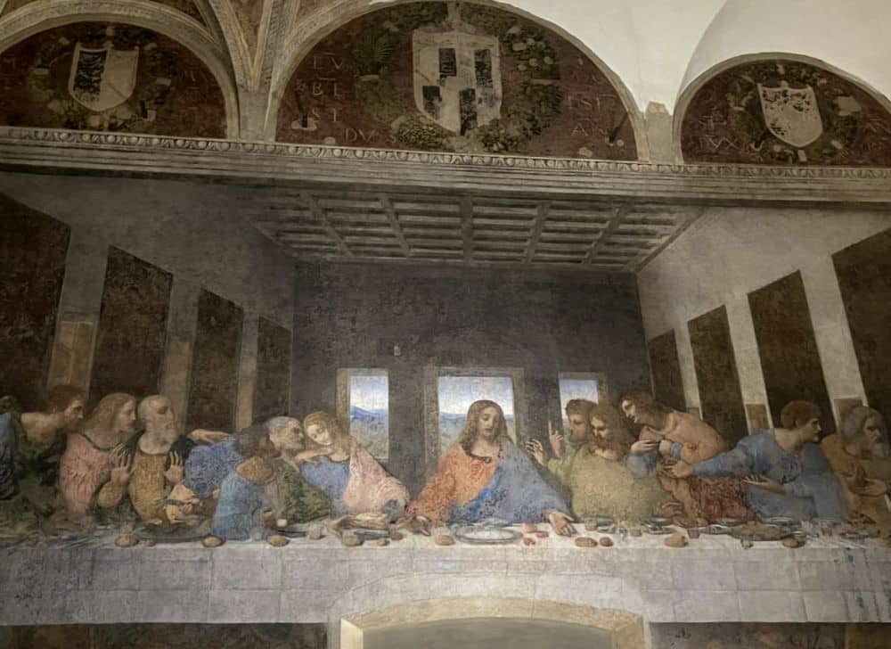 A partial image of The Last Supper by Leonardo da Vinci, a fresco. It is missing a bit on the left and right.