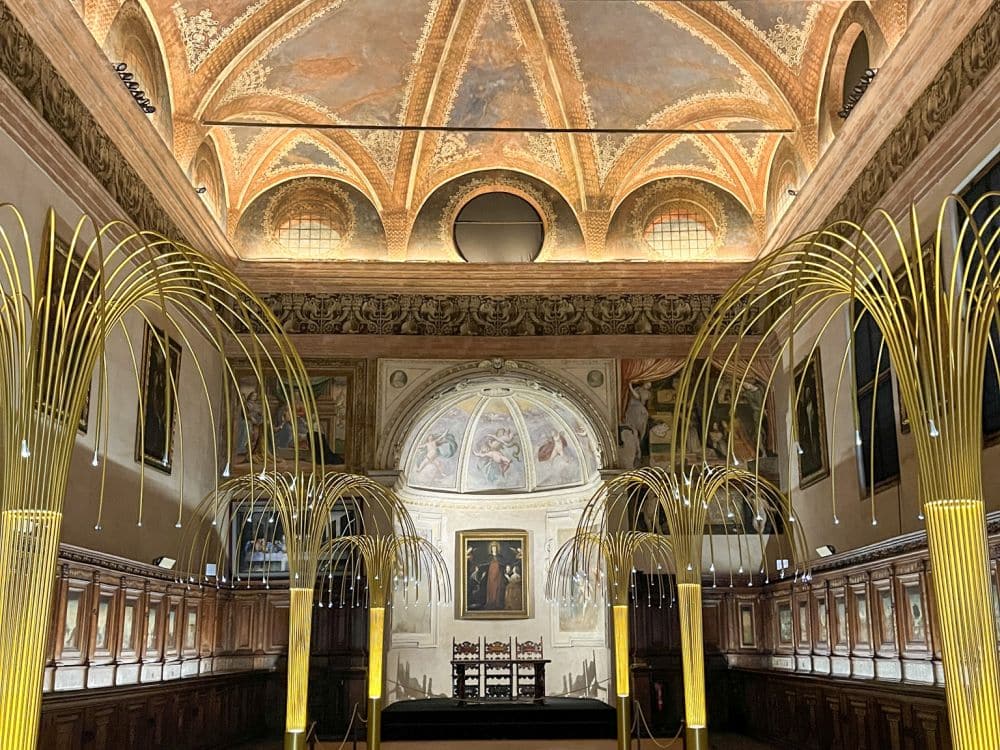 An ornate room with a high, arched, painted ceiling and painted walls.
