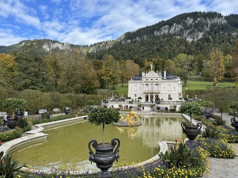Lindenhof seen from across an elegant formal pond in its gardens.