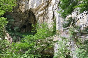 The entrance to a cave in a rock cliff.