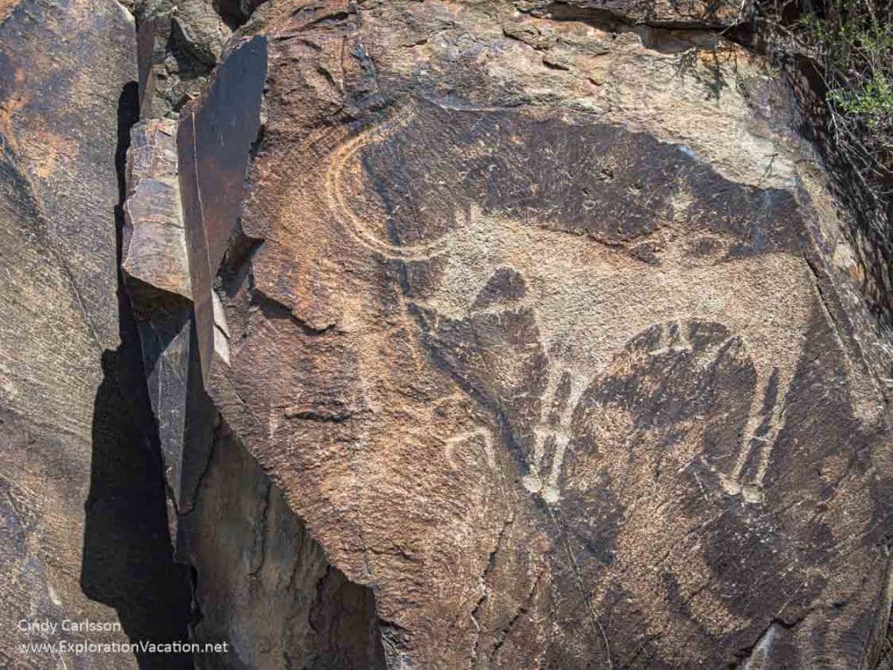 A carved image of a horse with a man sitting on it.