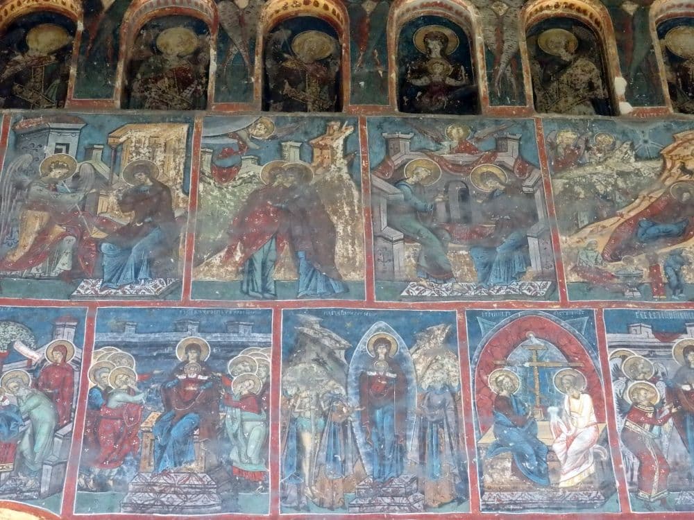A series of squares, each with a different scene of saints.