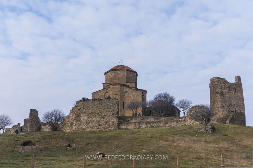 A church on a hill with a short, round central tower dome.