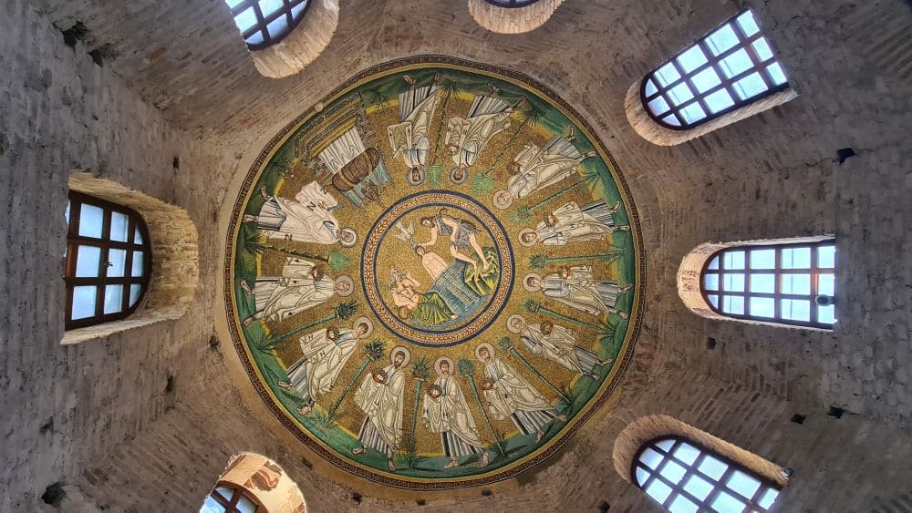 The baptism scene in the center, ringed by images of the apostles.