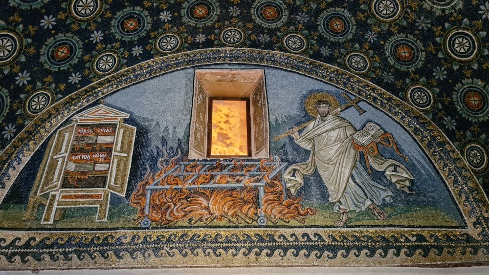 Mosaic with an image of a haloed person holding a cross on the left, a grill with flames below it in the center, and a cabinet with books inside it marked Mathew, Mark, Luke and John.