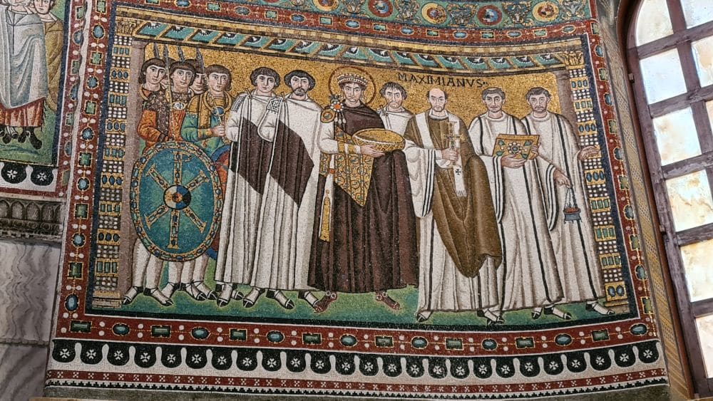 Justinian I in the center with a halo, soldiers on one side of him and men in robes on the other.