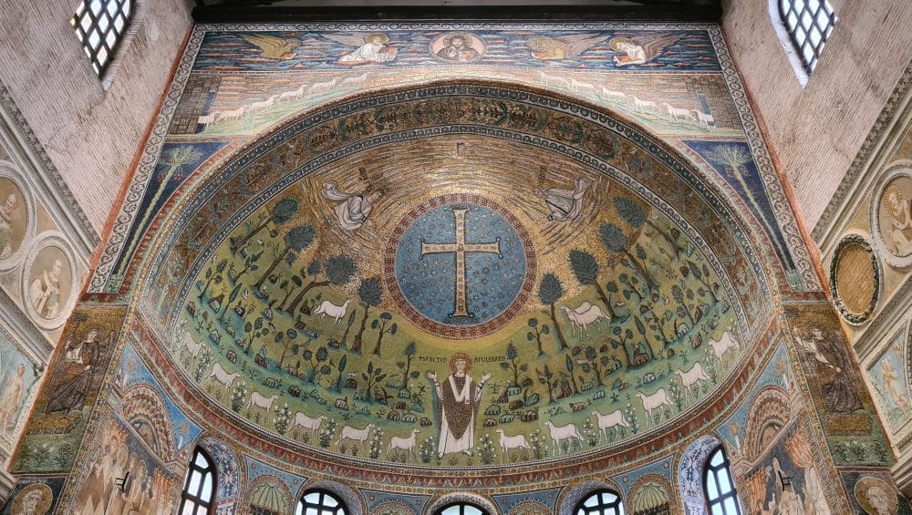A large cross in the center, St. Apollinare below it, with sheep on either side. 