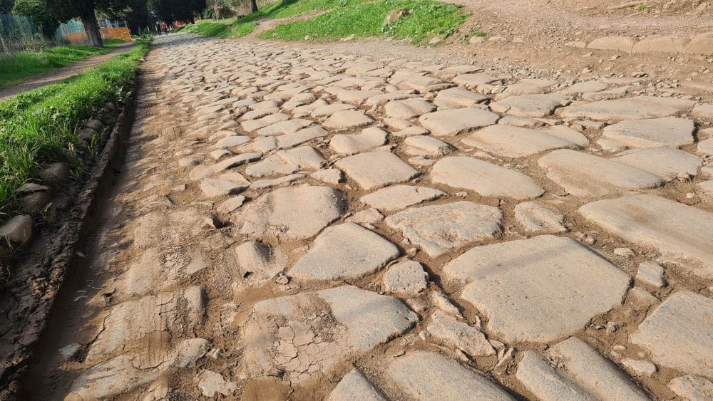 A road made of large flat stones, some with ruts in them.