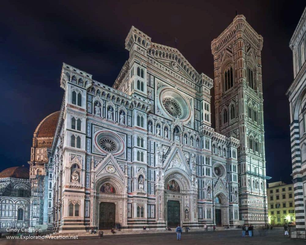 The facade has ornamentation built in through the use of both light and dark stones.