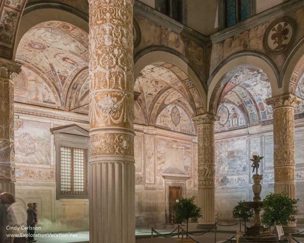 Ornately carved pillars and arches in white stone.