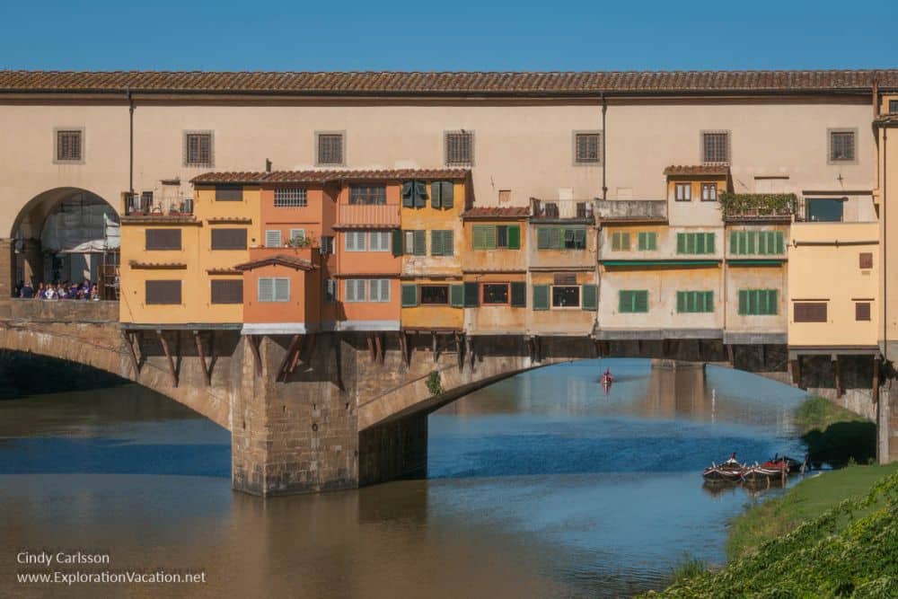 Arches support the bridge, which is covered with buildings of about four stories.