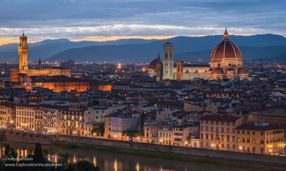 Nighttime view of the city, with churches and domes lit up.