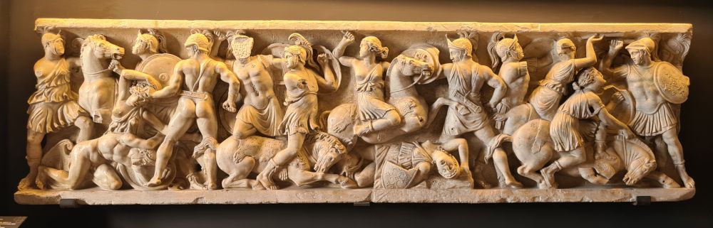 A detailed carved stone bas-relief of a battle.