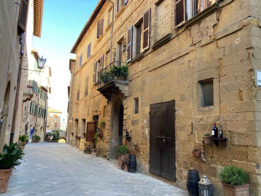 Looking along a street lined with simple buildings of 3 stories.
