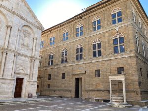 Part of the cathedral on the left with, at right angles to it, an elegant but simple palace of 3 stories.