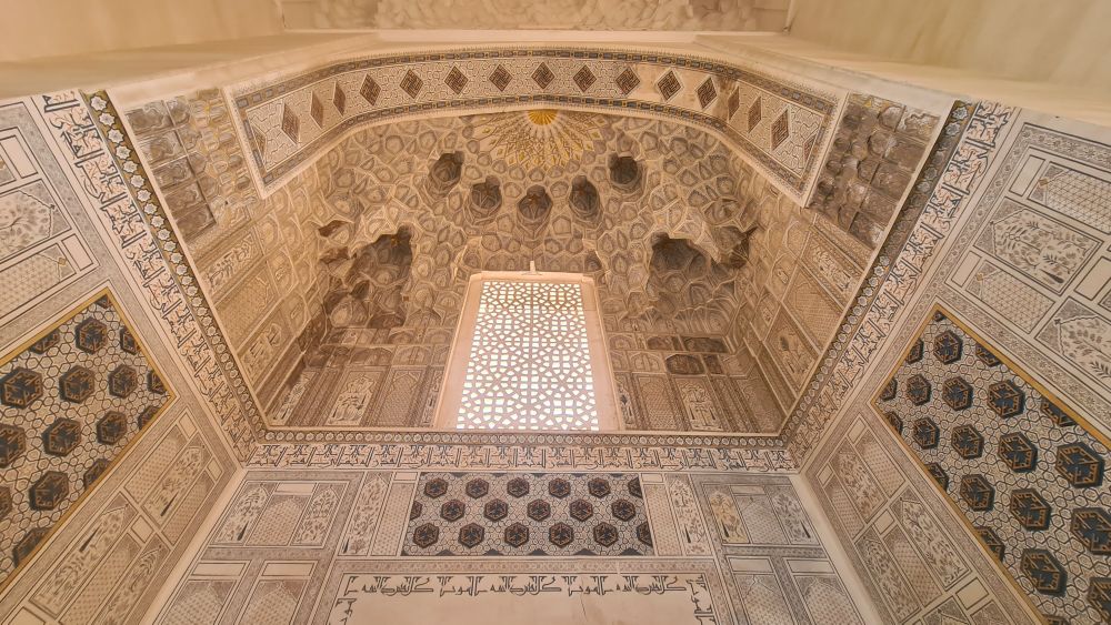 Detailed floral and geometric patterns extending up the walls and across the ceilng.