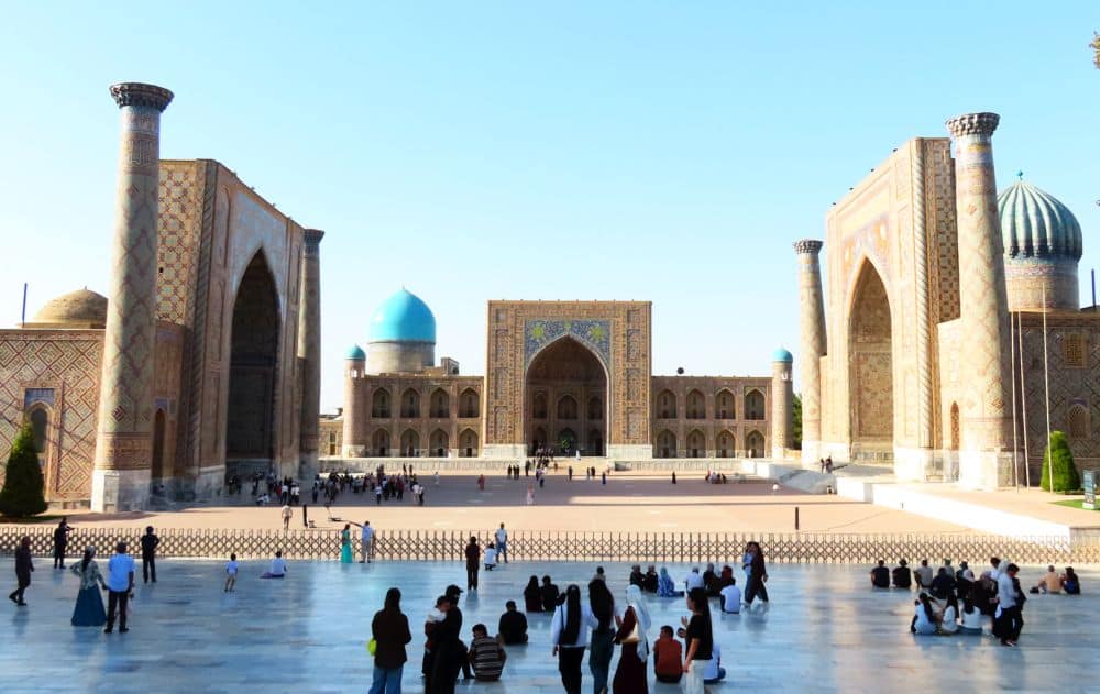 3 large buildings on 3 sides of a plaza. Each has a large central arch.